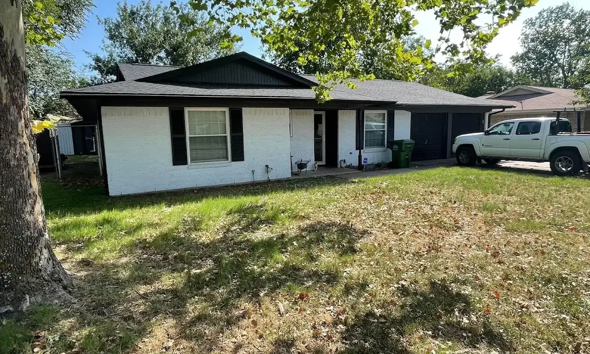 Professional roofing crew working on a residential roof in Carthage